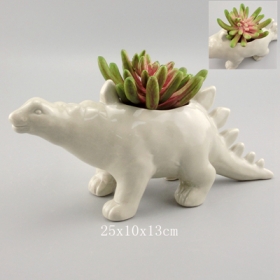 jardinera gris dinosaurio stegosaurus con plantas